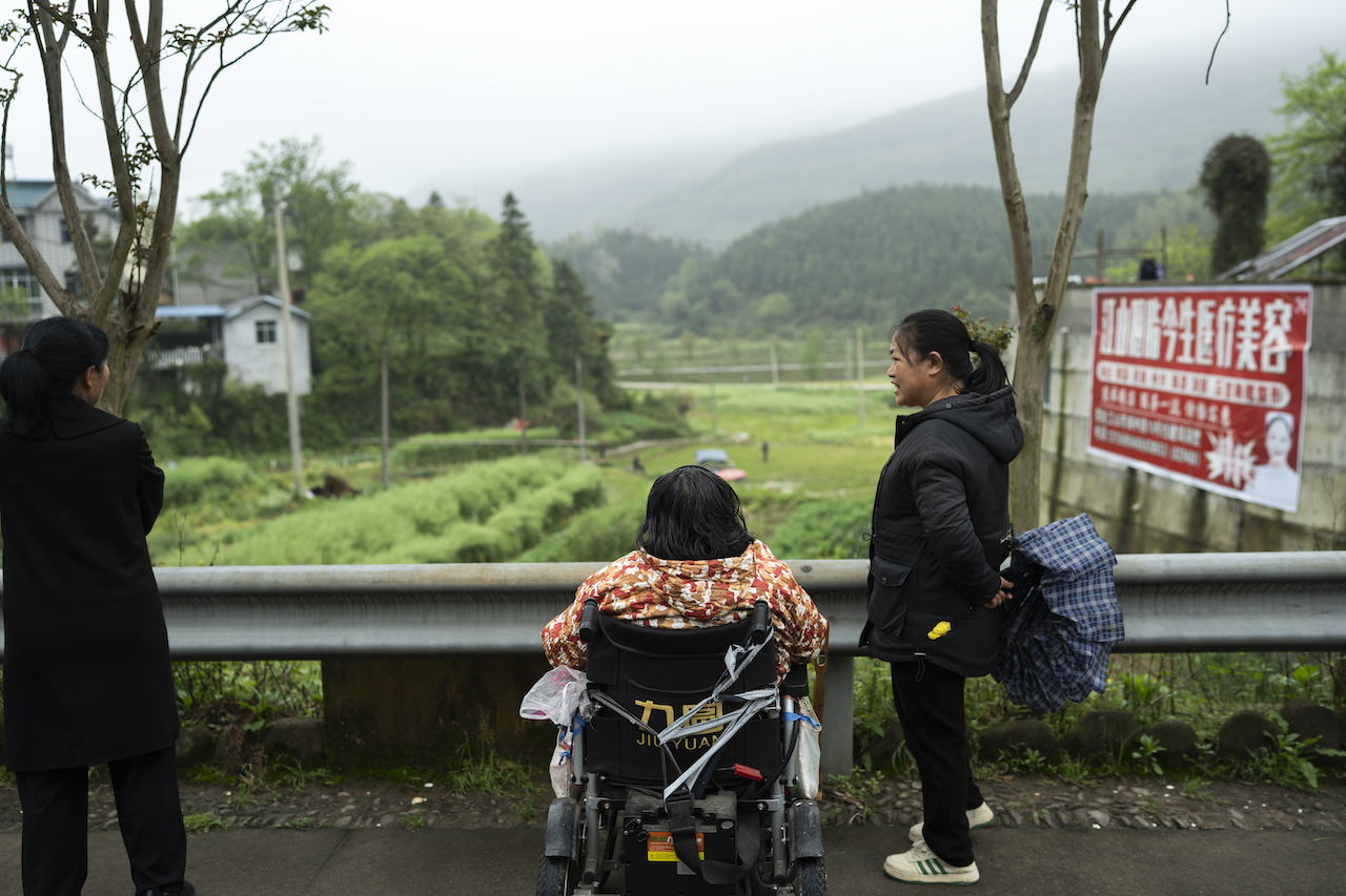 Villagers of Guangdu Cun looking out over the valley fields.